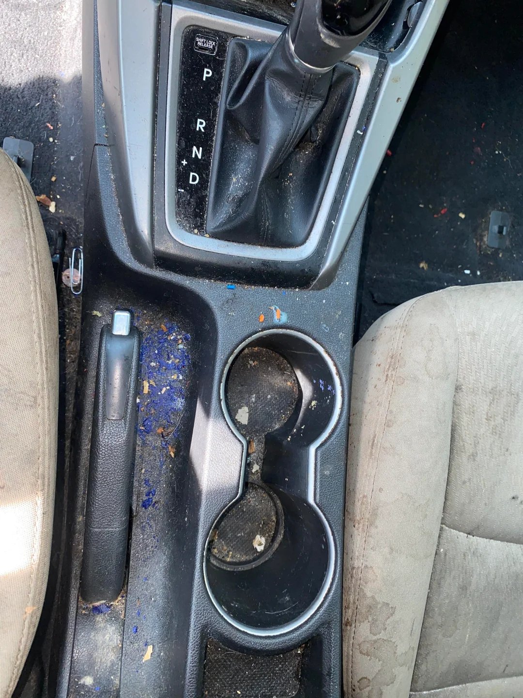 Detailed view of cup holder cleaning and restoration process