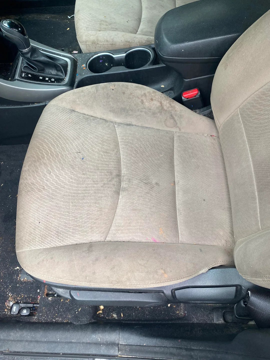 Vehicle driver seat before professional cleaning and restoration treatment